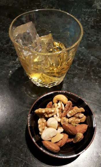 Highball drink and nuts. 